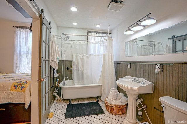 bathroom featuring shower with separate bathtub and toilet