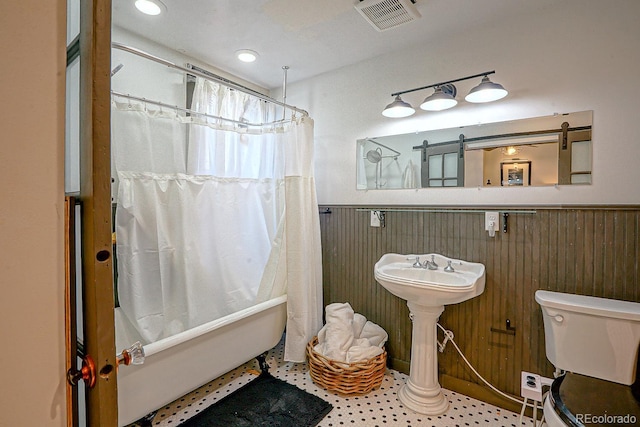 bathroom with shower / tub combo and toilet