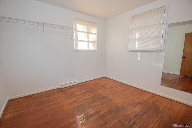 unfurnished room with hardwood / wood-style floors