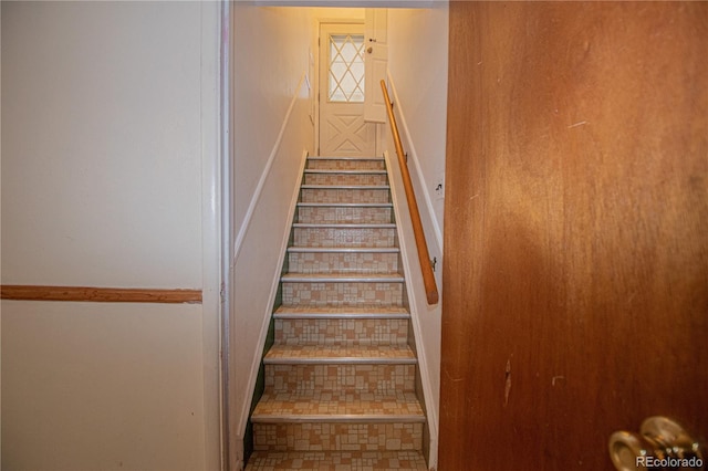 stairway with tile patterned flooring