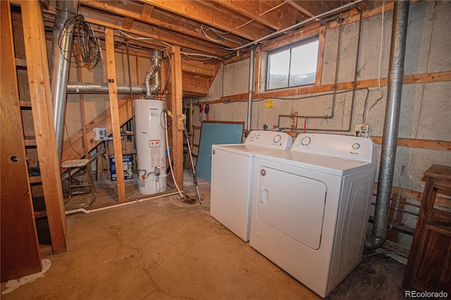 clothes washing area with washing machine and dryer and gas water heater