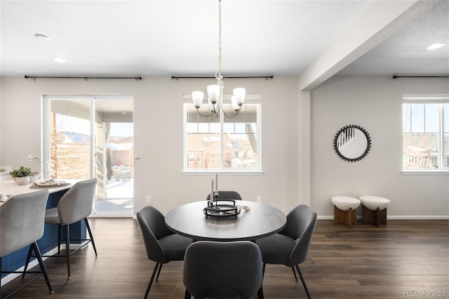 dining space featuring an inviting chandelier and dark hardwood / wood-style floors