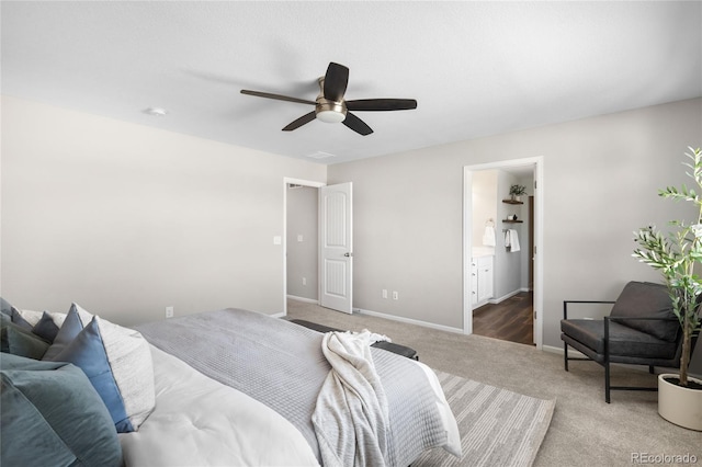 bedroom featuring ensuite bathroom, carpet flooring, and ceiling fan