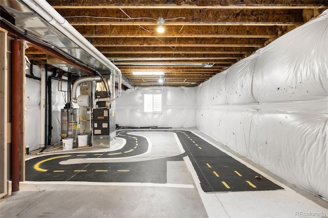 basement featuring heating unit and water heater