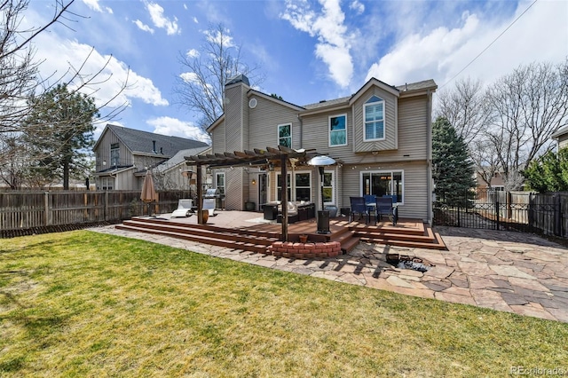 rear view of house with a lawn, a pergola, a fenced backyard, and a wooden deck