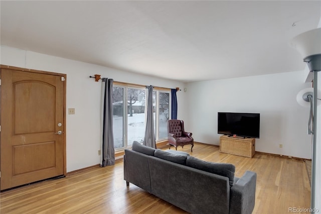 living room featuring light wood-style flooring and baseboards