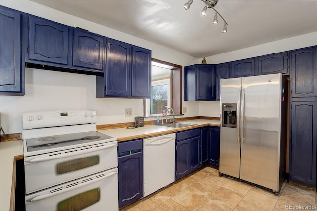 kitchen with blue cabinets, white appliances, light countertops, and a sink