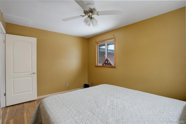 bedroom featuring light wood finished floors and a ceiling fan