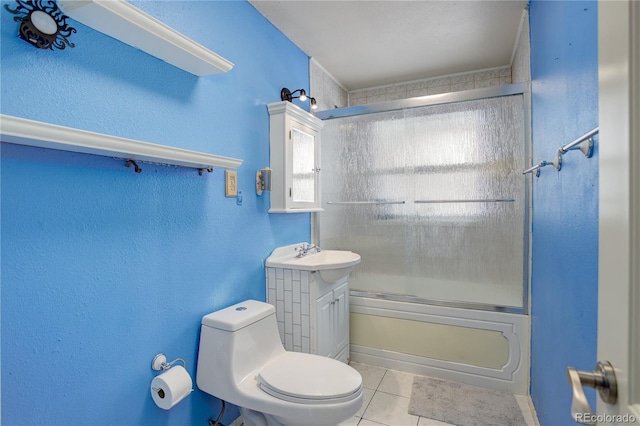 full bath featuring toilet, shower / bath combination with glass door, vanity, and tile patterned floors