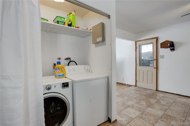 laundry area featuring washing machine and dryer, laundry area, and light tile patterned flooring