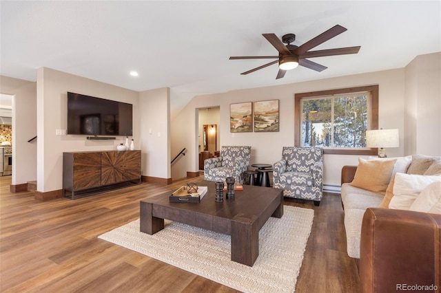 living room featuring baseboards, ceiling fan, wood finished floors, a baseboard heating unit, and recessed lighting