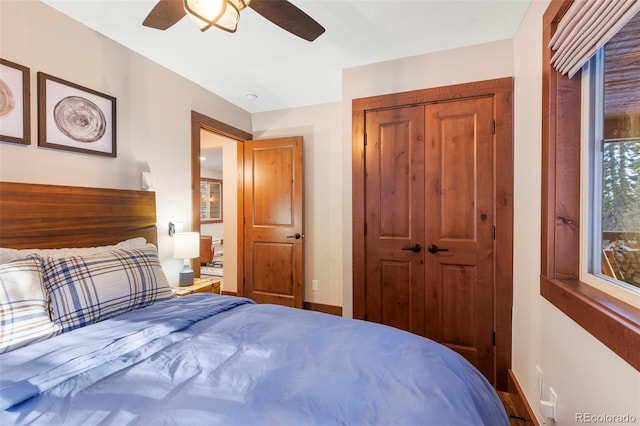 bedroom with a ceiling fan, a closet, and baseboards