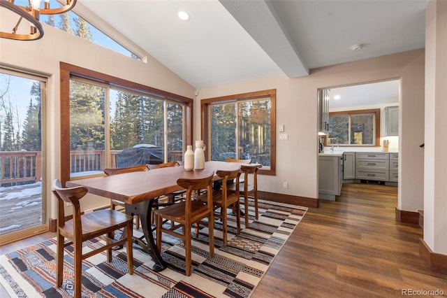 dining area with vaulted ceiling, dark wood-style flooring, plenty of natural light, and baseboards