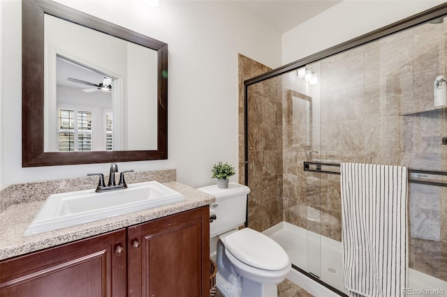 bathroom with radiator heating unit, toilet, ceiling fan, a shower stall, and vanity