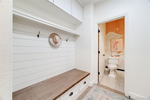 mudroom with light tile patterned flooring and baseboards