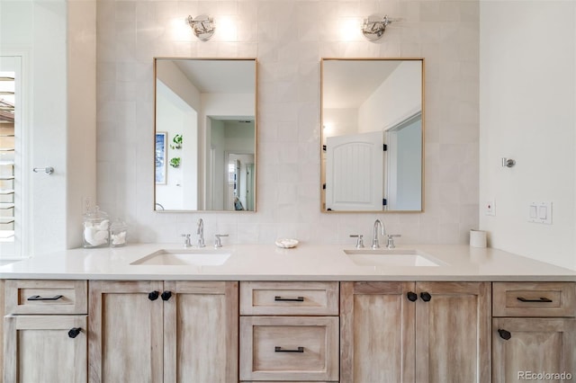 bathroom featuring a sink, tile walls, and double vanity