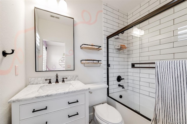 bathroom with toilet, shower / bath combination with glass door, visible vents, and vanity