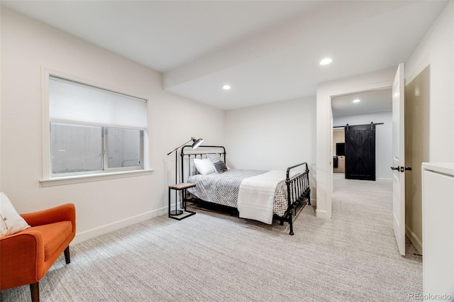 bedroom featuring light carpet, a barn door, baseboards, and recessed lighting