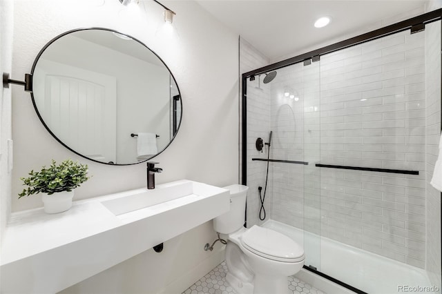 full bath with a stall shower, tile patterned flooring, a sink, and toilet