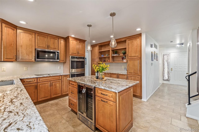 kitchen featuring light stone counters, appliances with stainless steel finishes, beverage cooler, and hanging light fixtures