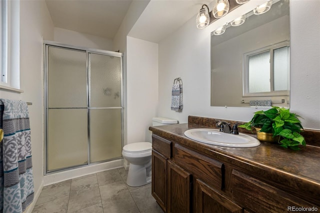 bathroom with vanity, toilet, and a shower with door