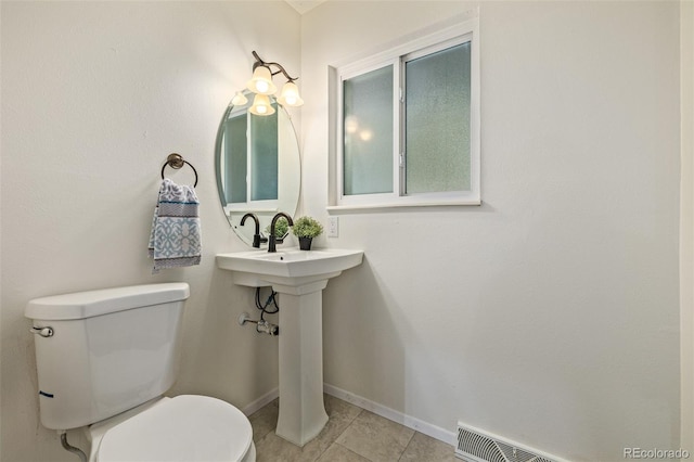 bathroom with tile patterned floors and toilet