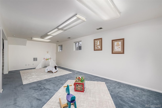 game room with dark colored carpet