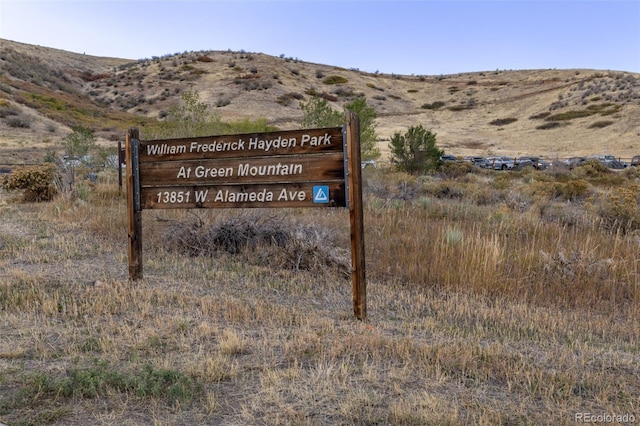 community sign with a mountain view