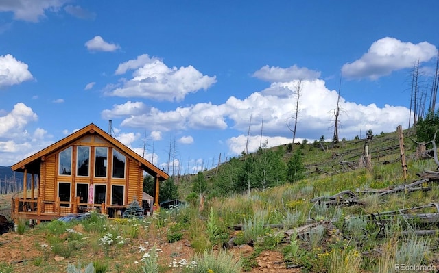 14077 S State Highway 67, Woodland Park, CO 80863 - rear view of house with faux log siding and a deck