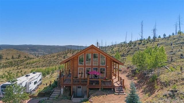 14077 S State Highway 67, Woodland Park, CO 80863 - rear view of property with a deck with mountain view, log exterior, and stairway