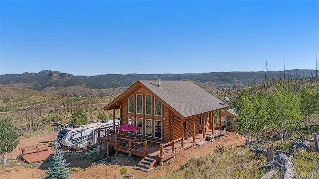 14077 S State Highway 67, Woodland Park, CO 80863 - rear view of property with a deck with mountain view, a shingled roof, and log exterior