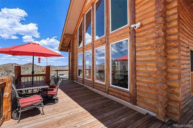 14077 S State Highway 67, Woodland Park, CO 80863 - wooden terrace with outdoor dining space and a mountain view