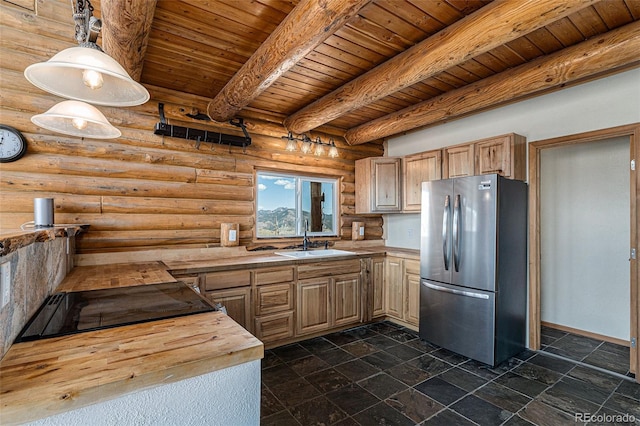 14077 S State Highway 67, Woodland Park, CO 80863 - kitchen featuring freestanding refrigerator, a sink, log walls, wooden ceiling, and butcher block counters