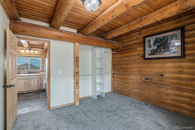 14077 S State Highway 67, Woodland Park, CO 80863 - unfurnished bedroom featuring a sink, carpet floors, beamed ceiling, wooden ceiling, and log walls