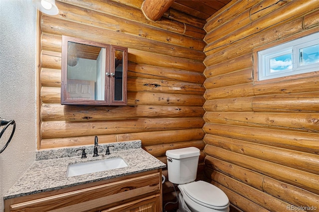 14077 S State Highway 67, Woodland Park, CO 80863 - bathroom with toilet, log walls, vanity, and a textured wall