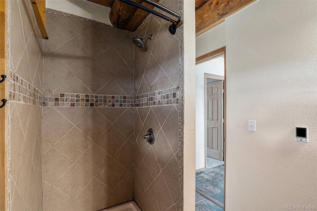 14077 S State Highway 67, Woodland Park, CO 80863 - full bathroom with a tile shower and a textured wall