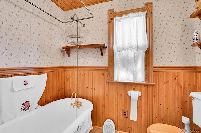 full bathroom featuring wallpapered walls and wainscoting