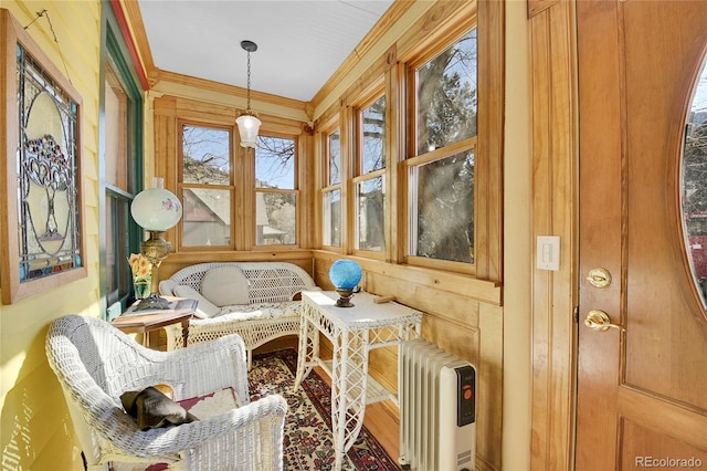 sunroom / solarium featuring radiator heating unit