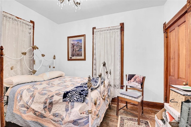 bedroom with wood finished floors and baseboards