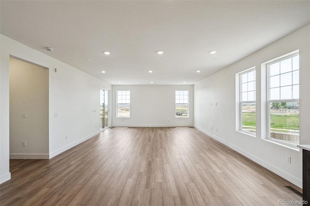 6384 E 154th Pl, Thornton, CO 80602 - unfurnished living room with wood finished floors, baseboards, and recessed lighting