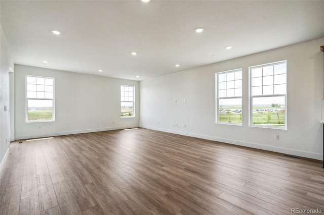 6384 E 154th Pl, Thornton, CO 80602 - spare room featuring wood finished floors, baseboards, and recessed lighting