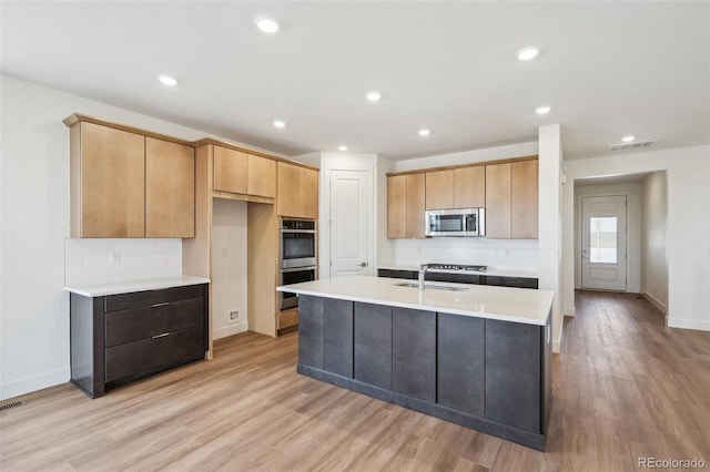 6384 E 154th Pl, Thornton, CO 80602 - kitchen with stainless steel appliances, backsplash, a sink, light wood-style flooring, and recessed lighting