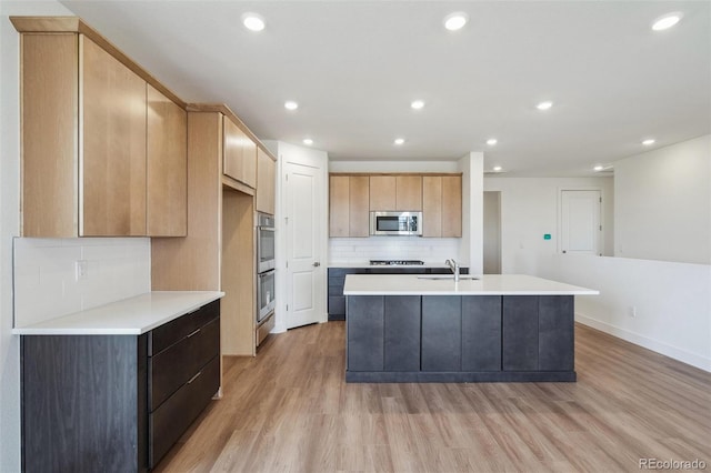 6384 E 154th Pl, Thornton, CO 80602 - kitchen featuring appliances with stainless steel finishes, light wood-type flooring, a sink, tasteful backsplash, and light countertops