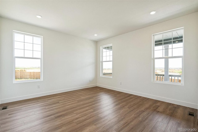 6384 E 154th Pl, Thornton, CO 80602 - spare room featuring wood finished floors, baseboards, and recessed lighting