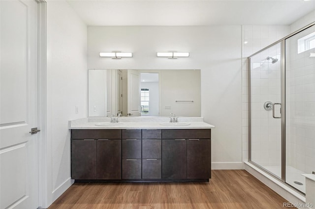 6384 E 154th Pl, Thornton, CO 80602 - full bath with a stall shower, wood finished floors, double vanity, and baseboards