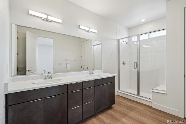 6384 E 154th Pl, Thornton, CO 80602 - full bathroom with double vanity, a shower stall, and wood finished floors
