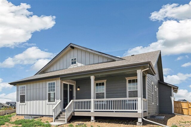 6384 E 154th Pl, Thornton, CO 80602 - view of front facade with a porch, board and batten siding, and roof with shingles