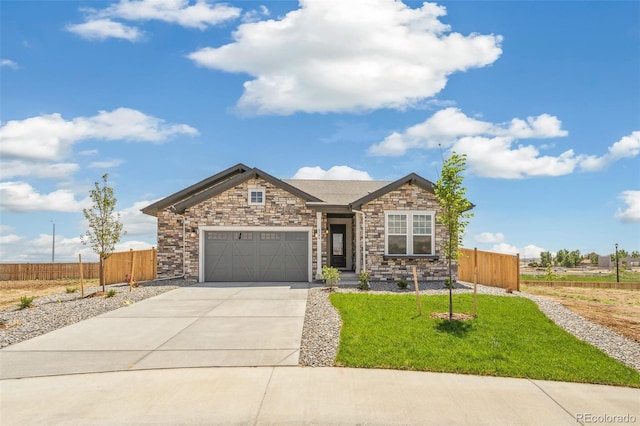 6384 E 154th Pl, Thornton, CO 80602 - view of front of home with stone siding, concrete driveway, and a garage