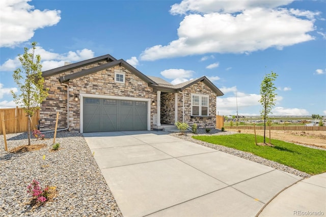 6384 E 154th Pl, Thornton, CO 80602 - view of front of house with concrete driveway, an attached garage, and stone siding