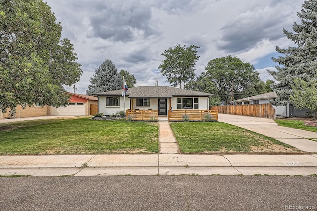 ranch-style home featuring a garage, a front yard, and covered porch